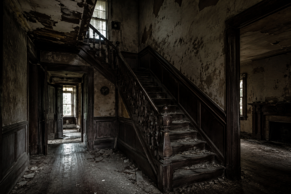 Creepy abandoned house interior with decaying staircase, peeling walls, dark hallways, and haunted atmosphere