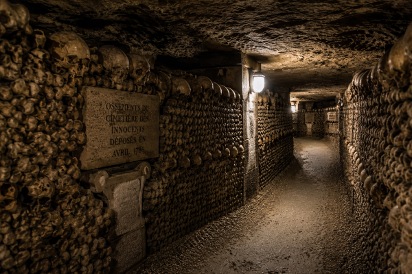 Paris Catacombs with dim lighting and ancient stone walls